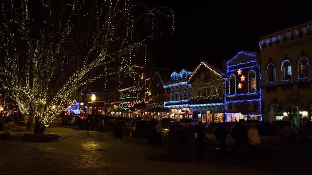 Christmas lights decorating a village street at night