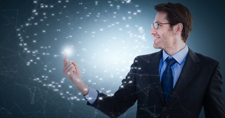 Composite image of smiling businessman pointing at a copy space