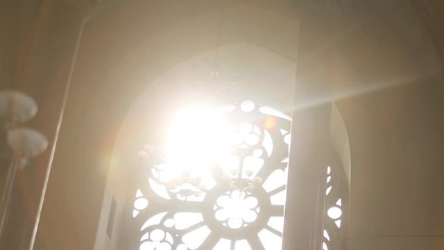 Sun shining through cathedral stained glass window, religion, faith