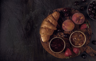Breakfast with croissant and jam on  board
