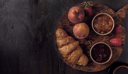 Breakfast with croissant and jam on  board