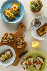 Healthy sandwiches with various fillings on crisp rye bread.