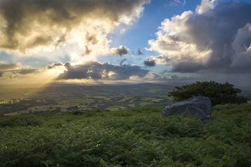 Sunrise as seen from caradon hill with blue cloudy sky, cornwall, uk