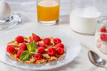 Wheat flakes with raspberries and milk.