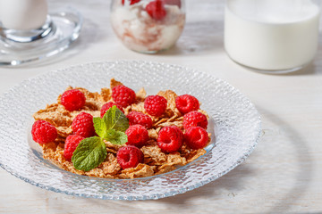 Wheat flakes with raspberries and milk.