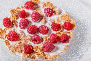 Wheat flakes with raspberries and milk.