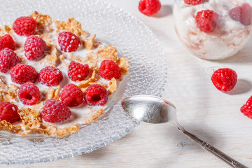 Wheat flakes with raspberries and milk.
