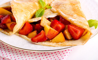 Pancakes with berry and fruit filling,