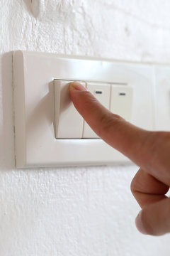 fingers are off light switch in the house.