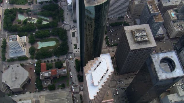 Slow flight with steep view down above buildings of downtown Houston; links to Solo Clip T523-16. Shot in 2007.