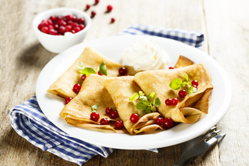 Pancakes with cranberry and whipped cream
