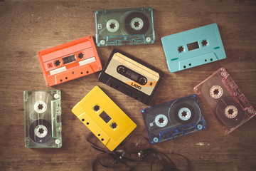 Top view (above) shot of retro tape cassette on wood table - vintage color effect styles.
