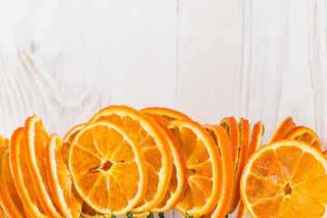 slices of orange on a white wooden table background