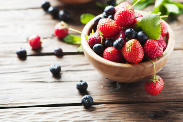 Red sweet strawberry and blueberry on the wooden table