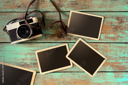 retro camera and empty old instant paper photo album on wood table old style photo albums