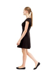 back view of walking  woman in dress.