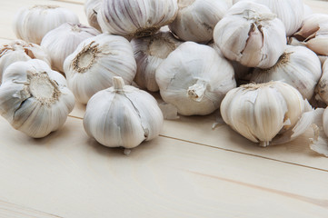 Organic garlic whole and cloves on the wooden background
