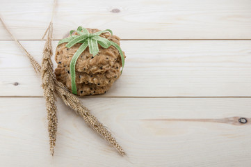Place the cookies with a ribbon tied on a wooden floor.