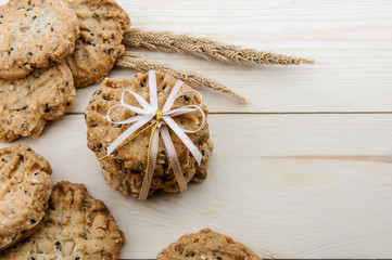 Place the cookies with a ribbon tied on a wooden floor.