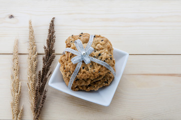 Place the cookies with a ribbon tied on a wooden floor.