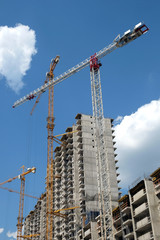 New high-rise modern apartment buildings construction in process ob bright sunny day side view vertical