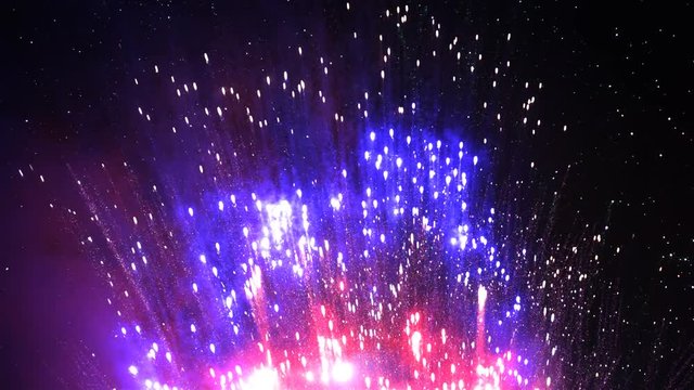 Red, white, and blue explode upward in ultra slow motion