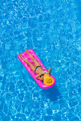 woman at the pool on a lilo