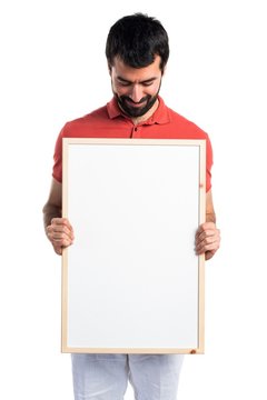 Handsome man holding an empty placard