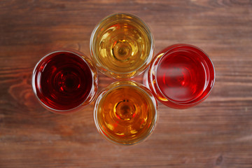 Glasses with wines of different colors on a wooden table