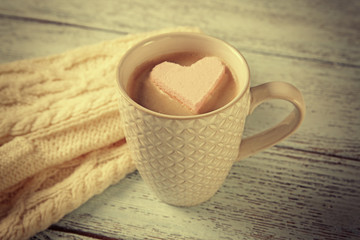 Cup of coffee with marshmallow on wooden table