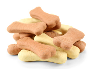 Pile of dog biscuit bones on white background