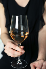 Woman holding glass of wine, closeup