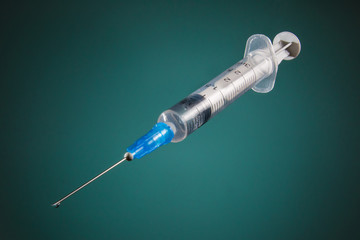 Syringe with a medicine on a dark background