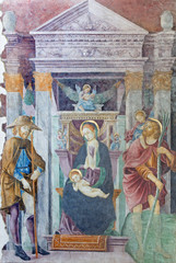 BRESCIA, ITALY - MAY 21, 2016: The fresco of Madonna with the St. Christopher and St. Roch in church Chiesa del Santissimo Corpo di Cristo by Paolo Caylina il Vecchio (cca 1501).