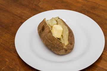Hot Buttered Potato on White Plate