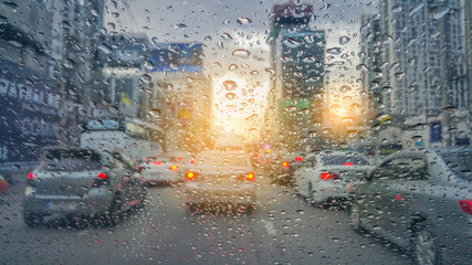 Defocussed traffic viewed through a car windscreen covered