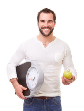 Happy man with scale weight and green apple
