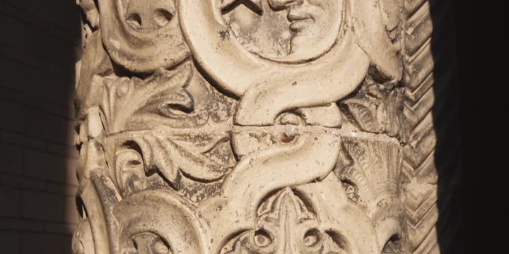 Pan up on details of an ornately carved pillar
