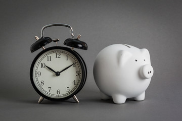 pink ceramic piggy bank over a grey background