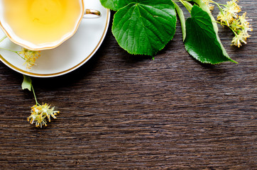 porcelain Cup of Linden tea on a background of dark wood