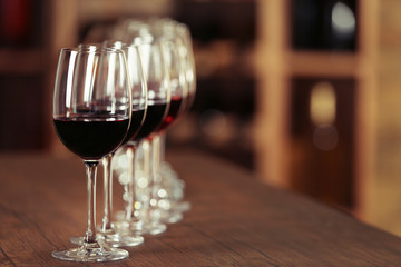 Many glasses of different wine in a row on bar counter
