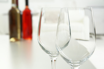 Wineglasses on blurred interior background