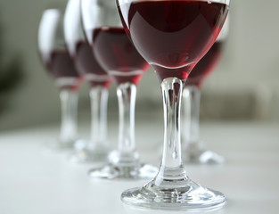 Glasses of red wine on white table closeup
