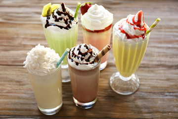 Delicious milkshakes on wooden table