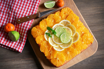 Delicious citrus cake on wooden background