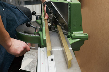 Craftsman working on frame in frameshop.