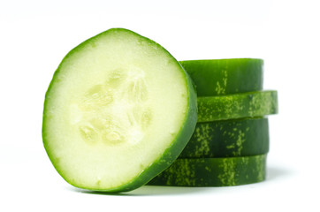 Stack of sliced cucumbers on white background
