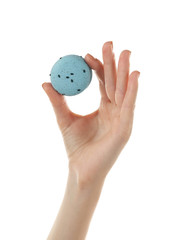 Tasty macaroon in woman hand, isolated on white