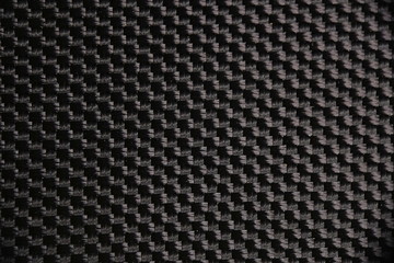 Macro photograph of a black nylon mesh fabric. Details, textures, backgrounds and patterns