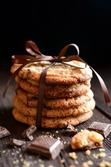 Homemade chocolate chip cookies on black background